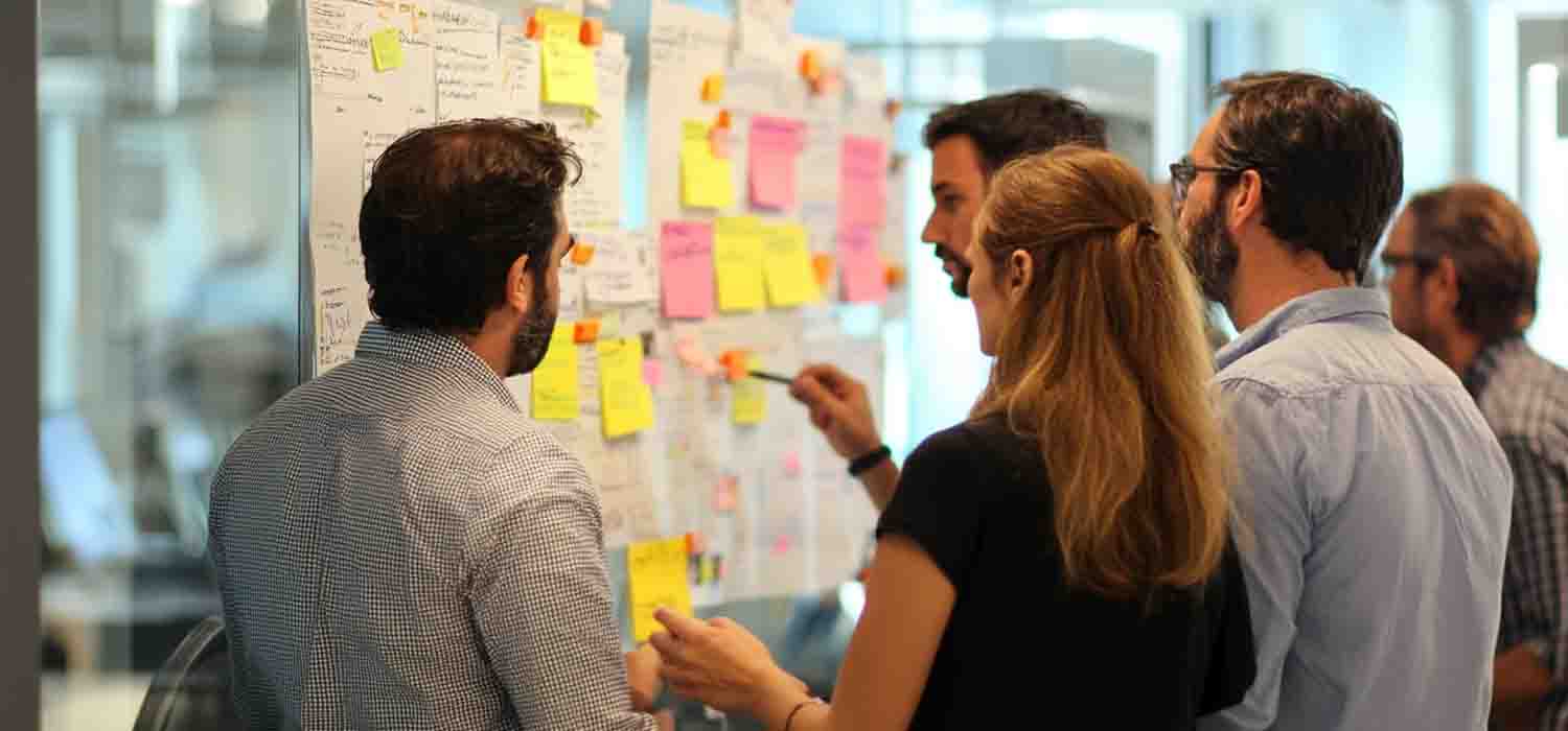 team collaborating using project management and CRM software tools in an office